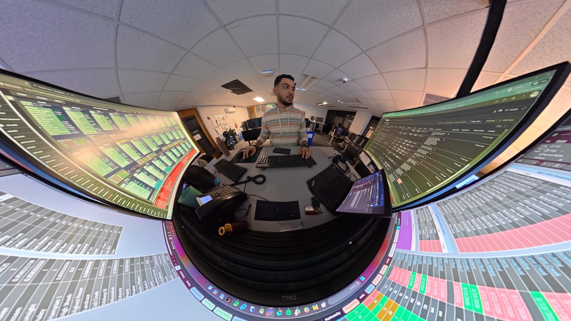 Performance engineer working across multiple monitors in the control room