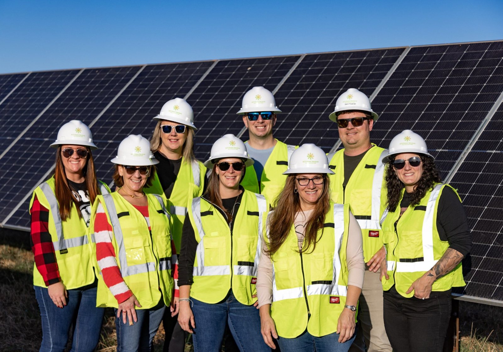 ACT field team in hard hats and safety vests at a solar site