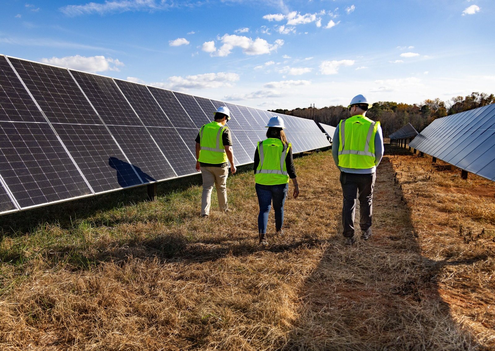 Inspection crew walking a solar array under construction